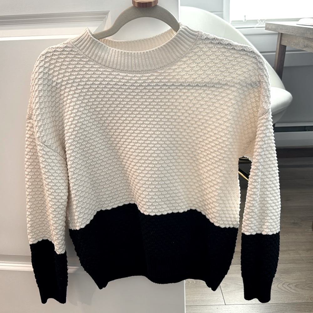Size smaller black/white sweater in perfect condition